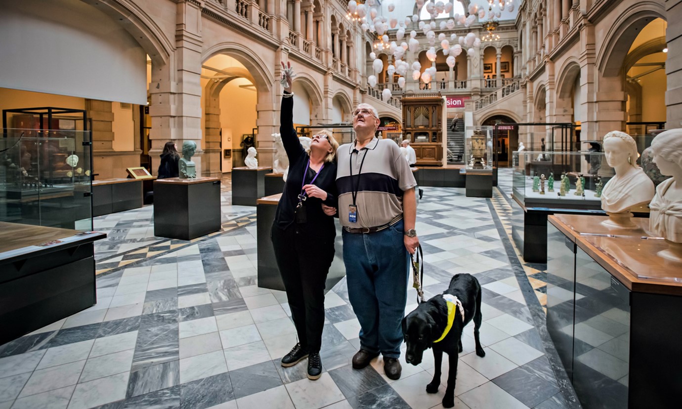 A man is guided around the exhibits on display at The Kelvingrove Art Gallery and Museum